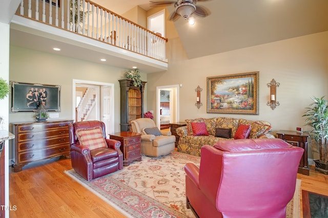 living room with high vaulted ceiling, light wood-type flooring, and ceiling fan