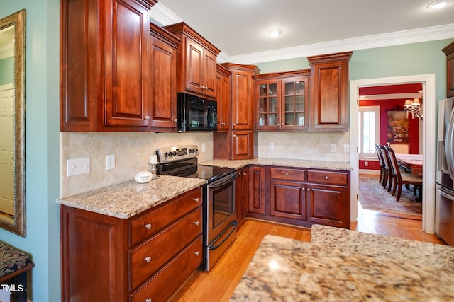 kitchen featuring light stone counters, backsplash, stainless steel appliances, crown molding, and light hardwood / wood-style floors