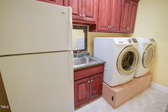 clothes washing area with light tile patterned floors, cabinets, sink, and washing machine and dryer