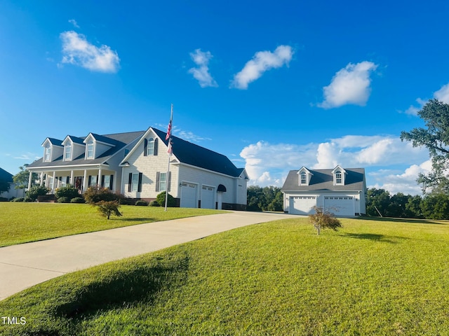 view of front facade featuring a garage, a front lawn, and covered porch