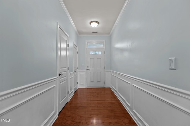 doorway to outside featuring dark wood-type flooring and ornamental molding