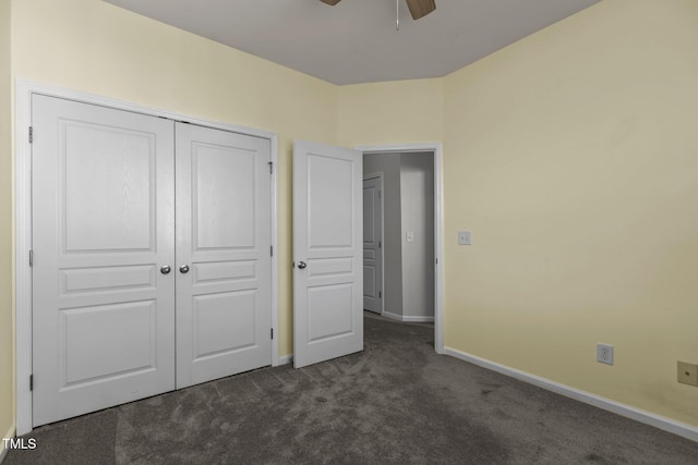 unfurnished bedroom with a closet, ceiling fan, and dark carpet