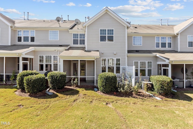 back of house featuring a sunroom and a yard