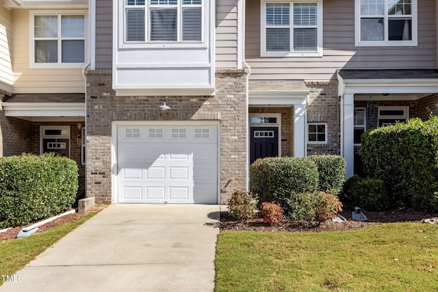 view of front of property with a garage and a front yard