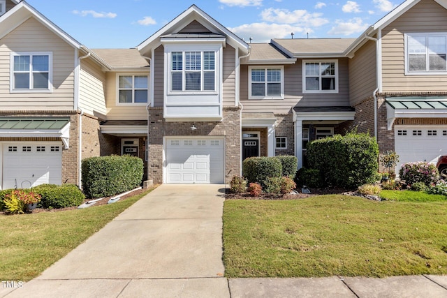 view of property featuring a garage and a front lawn