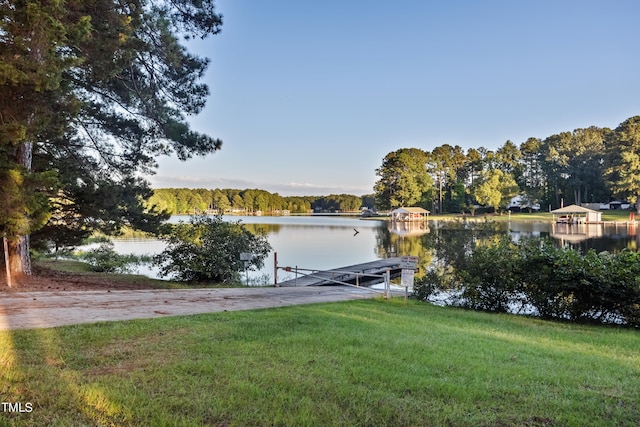 dock area featuring a water view and a yard