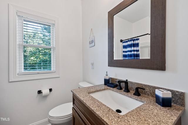 bathroom featuring vanity, toilet, and a shower with shower curtain