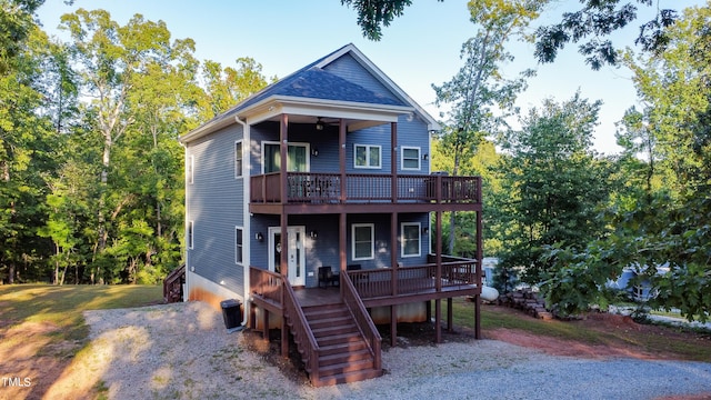 back of house with a deck and ceiling fan