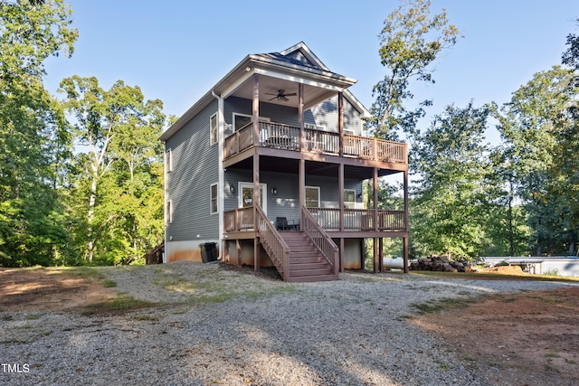 rear view of house with a deck and ceiling fan