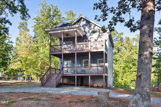 rear view of house featuring a wooden deck