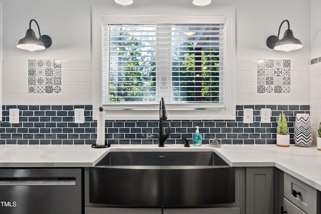 kitchen featuring dishwasher, backsplash, sink, and gray cabinets