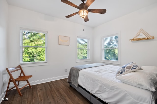 bedroom with ceiling fan and dark hardwood / wood-style floors