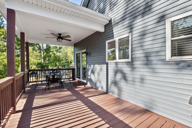 wooden deck featuring ceiling fan