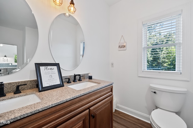 bathroom featuring vanity, toilet, and hardwood / wood-style flooring