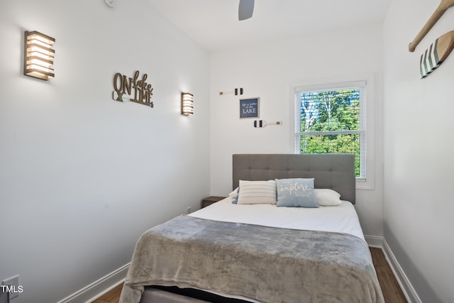 bedroom with dark wood-type flooring and ceiling fan