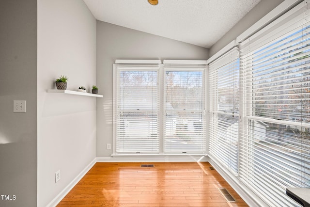 unfurnished sunroom featuring lofted ceiling