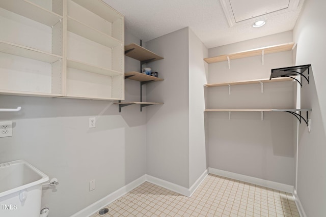 laundry area with sink and a textured ceiling