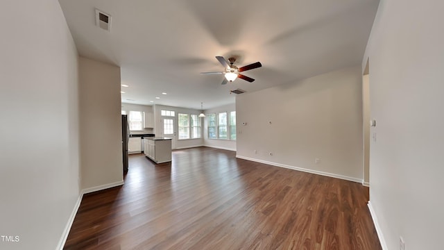 unfurnished living room with ceiling fan and dark hardwood / wood-style floors