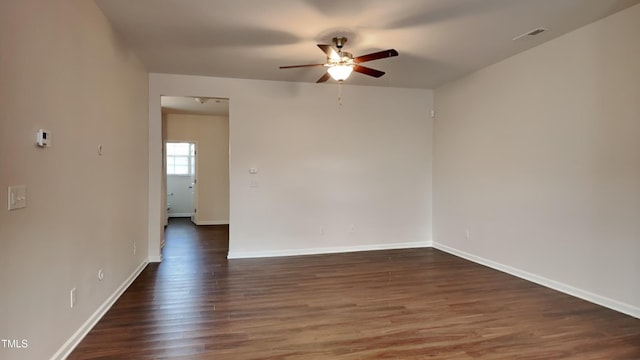 empty room with dark hardwood / wood-style floors and ceiling fan