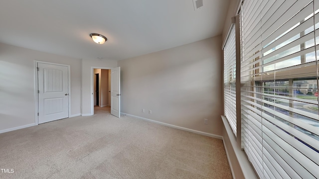 unfurnished room with light carpet