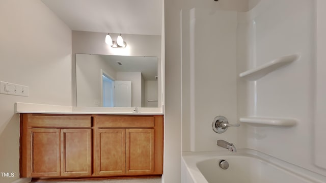 bathroom featuring shower / tub combination and vanity