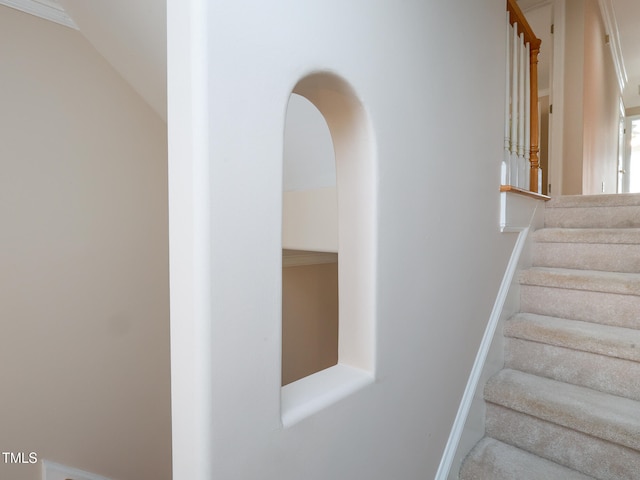 stairs featuring crown molding