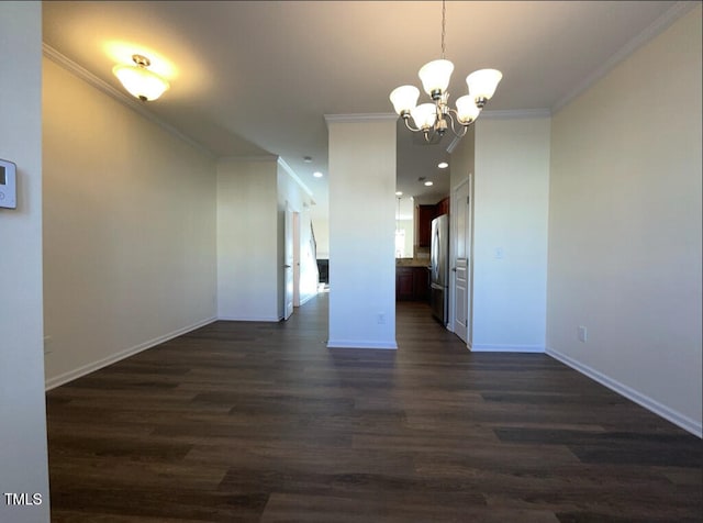 unfurnished dining area featuring dark hardwood / wood-style floors, ornamental molding, and an inviting chandelier