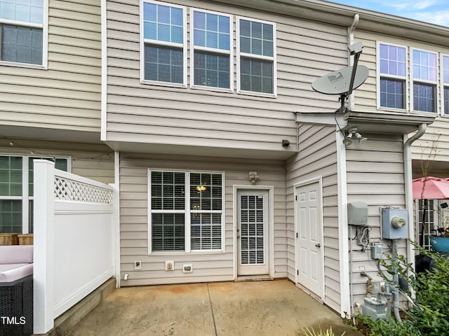 view of exterior entry featuring a patio area