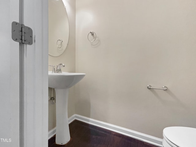 bathroom featuring hardwood / wood-style floors and toilet