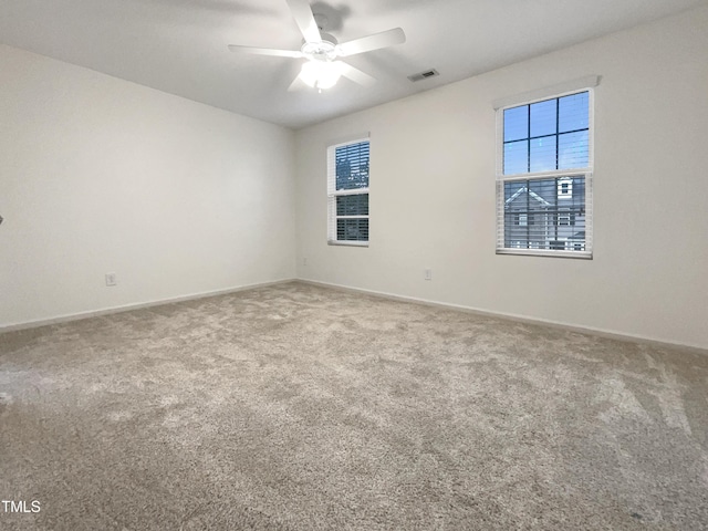 empty room featuring ceiling fan and carpet floors