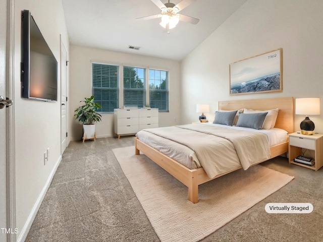 carpeted bedroom with vaulted ceiling and ceiling fan