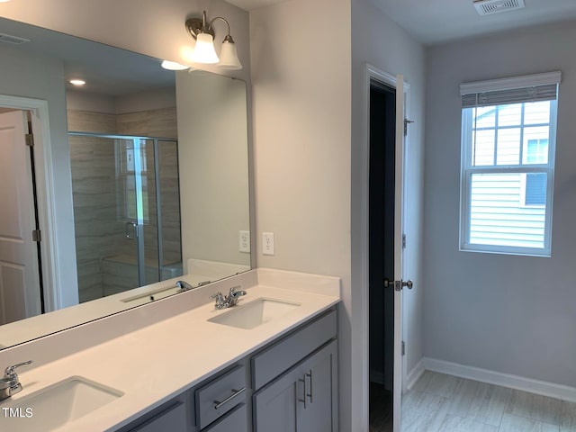 bathroom featuring an enclosed shower and vanity