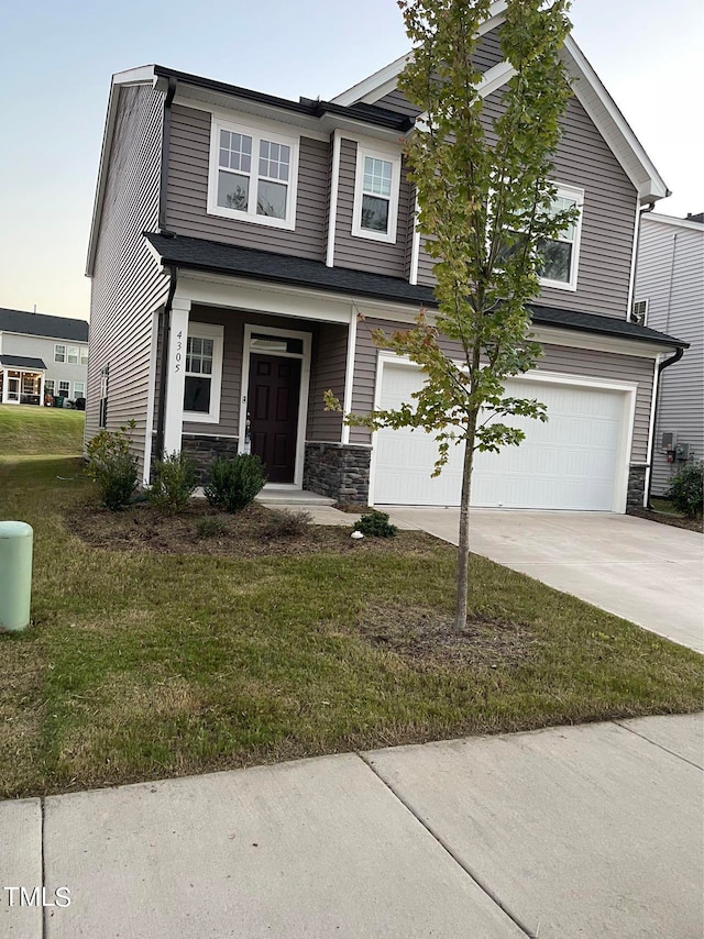 view of front of house featuring a front lawn and a garage