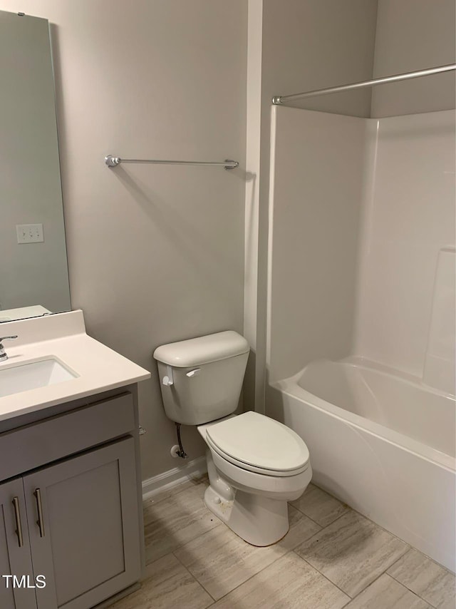 full bathroom featuring tub / shower combination, vanity, and toilet