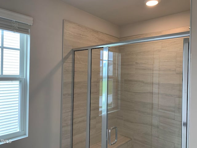 bathroom with a shower with shower door