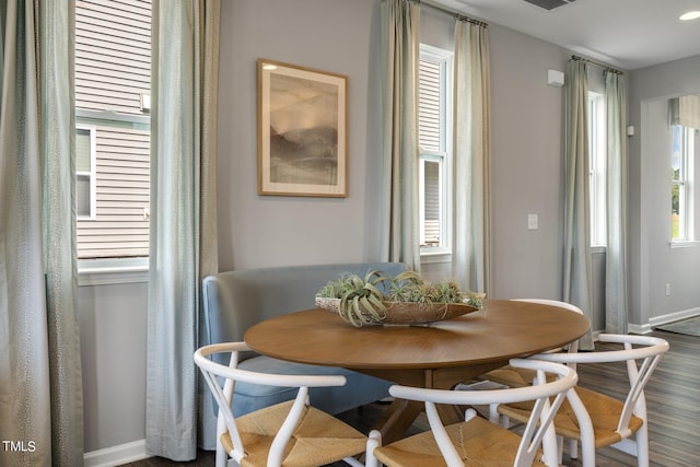 dining area featuring dark wood-type flooring