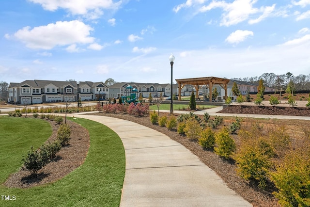 view of home's community with a playground and a lawn