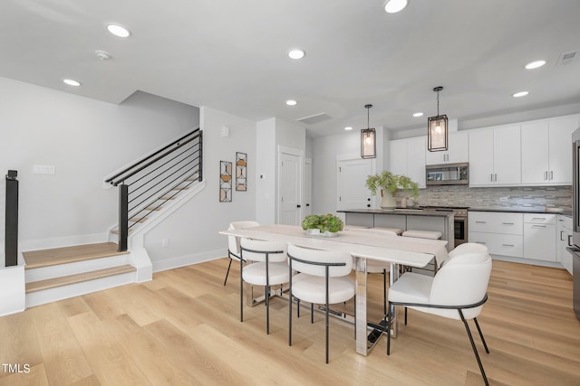 dining space with light hardwood / wood-style flooring