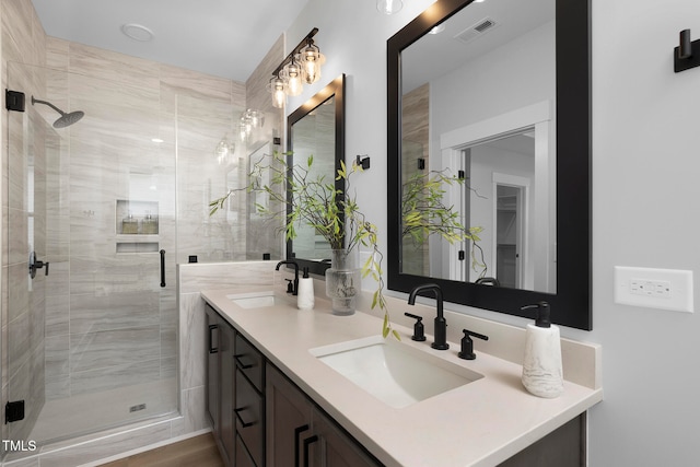 bathroom with a shower with door, vanity, and hardwood / wood-style floors