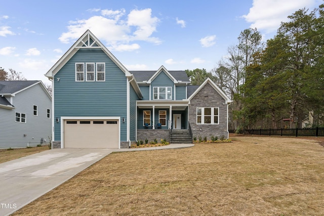 craftsman house with a garage, a front lawn, and covered porch