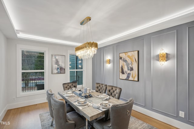 dining area featuring an inviting chandelier and light wood-type flooring