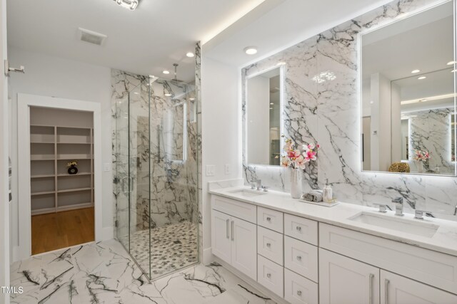 bathroom with vanity and a shower with shower door