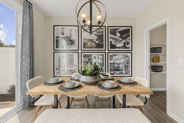 dining space featuring hardwood / wood-style flooring and a notable chandelier