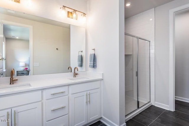 1206 Holding Village Way, Wake Forest, NC 27587 - bathroom with baseboards, double vanity, a shower stall, tile patterned floors, and recessed lighting