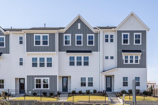 1206 Holding Village Way, Wake Forest, NC 27587 - townhome / multi-family property featuring board and batten siding and a fenced front yard