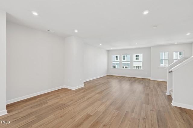 1206 Holding Village Way, Wake Forest, NC 27587 - empty room featuring light wood-style flooring, recessed lighting, baseboards, and stairway