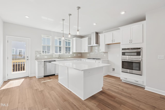 1206 Holding Village Way, Wake Forest, NC 27587 - kitchen with appliances with stainless steel finishes, wall chimney exhaust hood, white cabinetry, tasteful backsplash, and recessed lighting