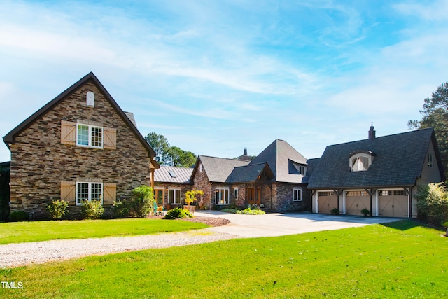 view of front of home featuring a front yard and a garage