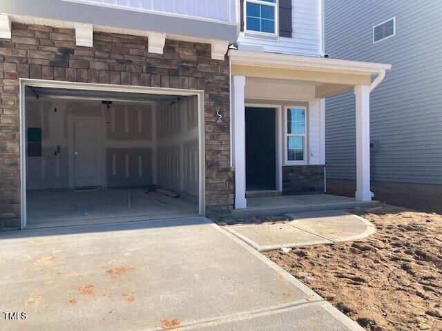 doorway to property with a garage