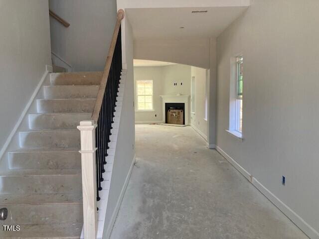 staircase with concrete flooring